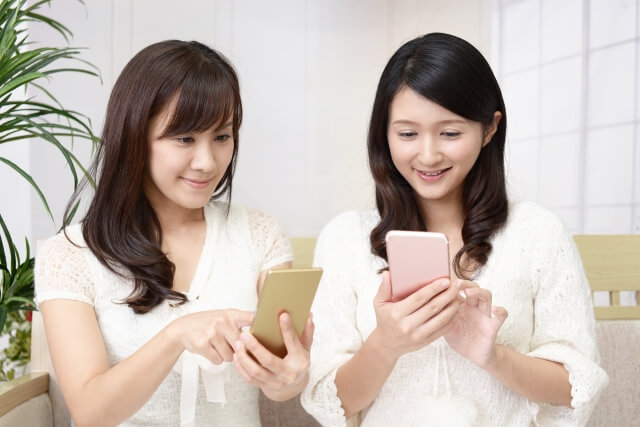 スマホを見ている二人の女性